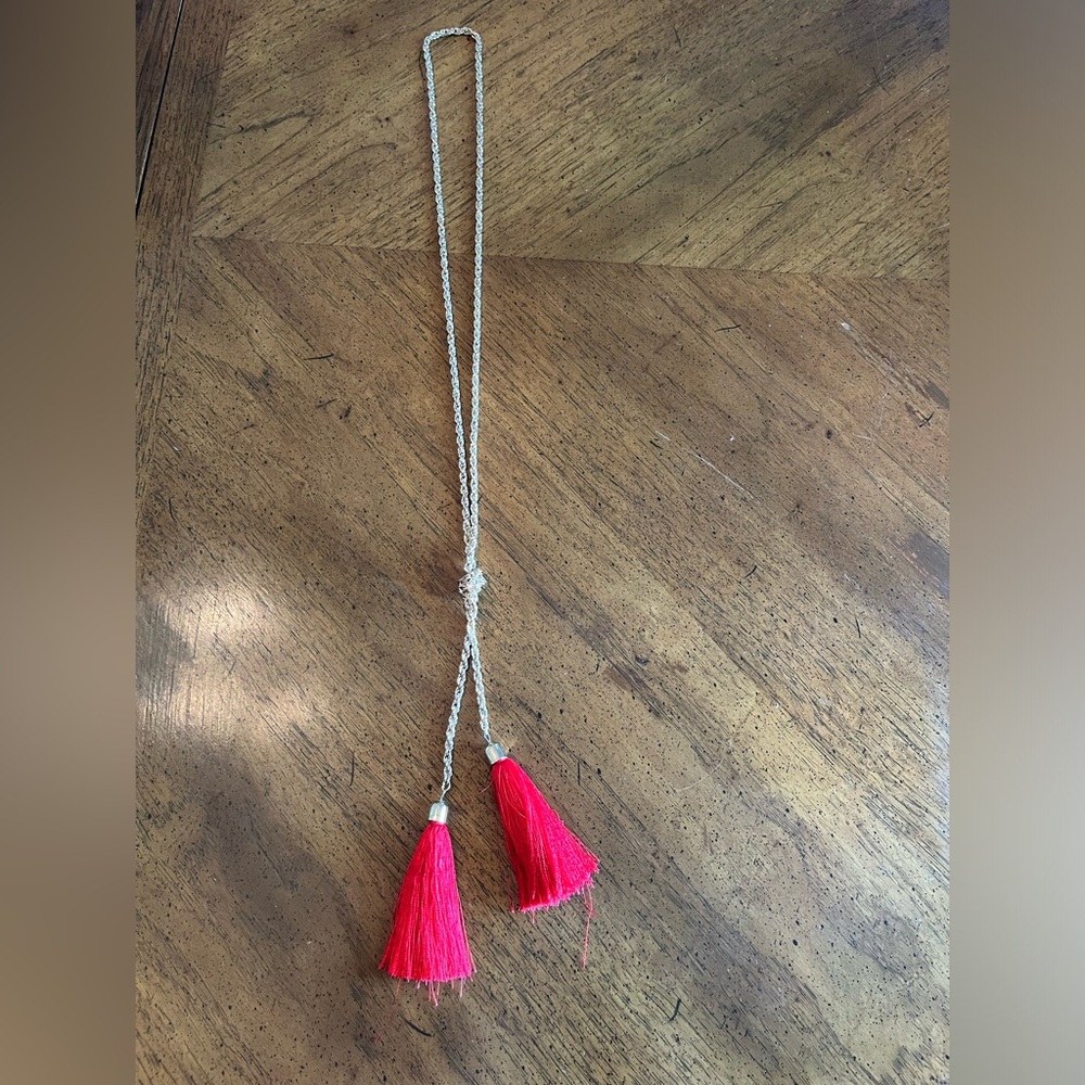 Red tassel necklace, gold chain.